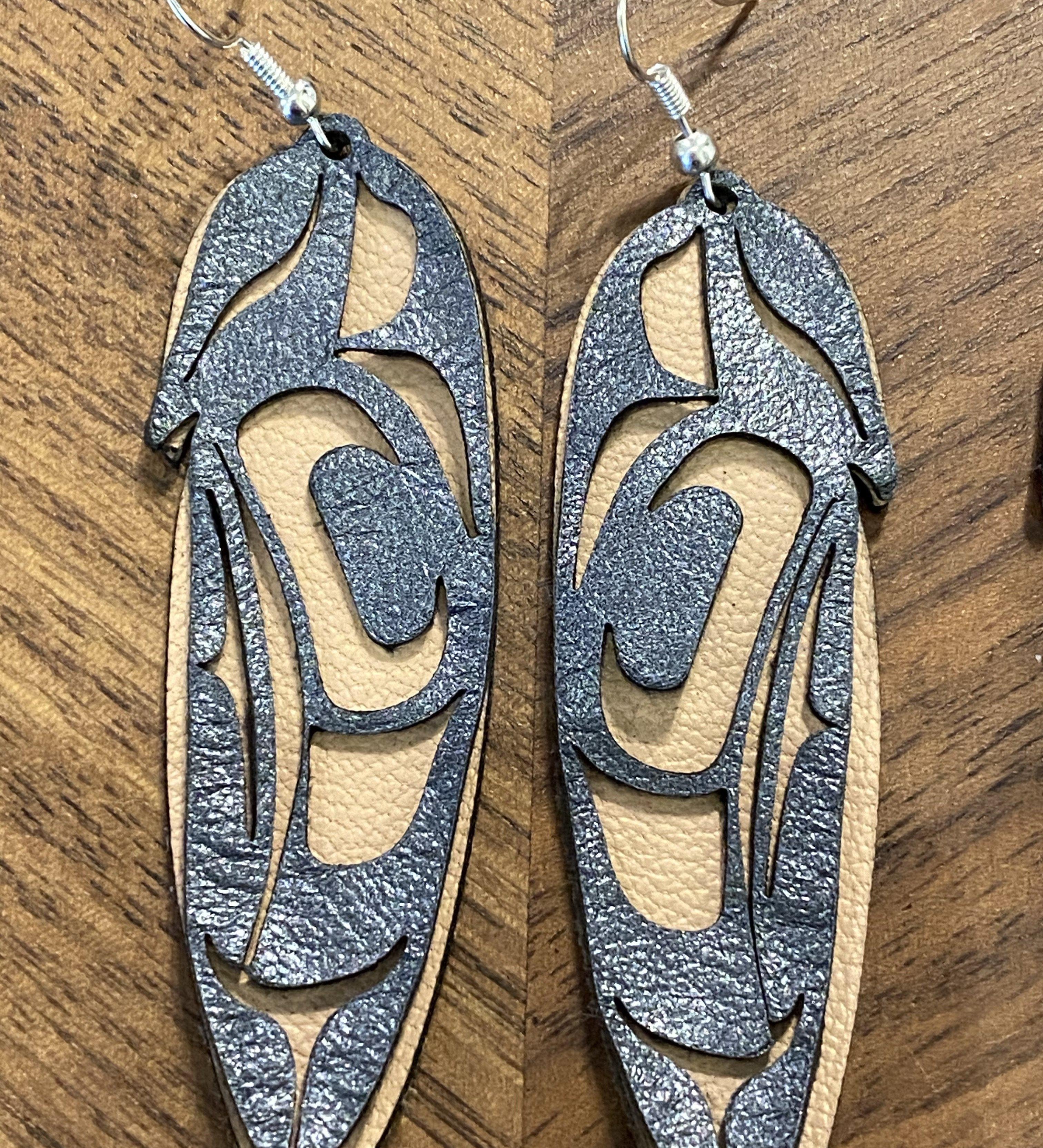 Close up of feather earrings by indigenous artist leather 4