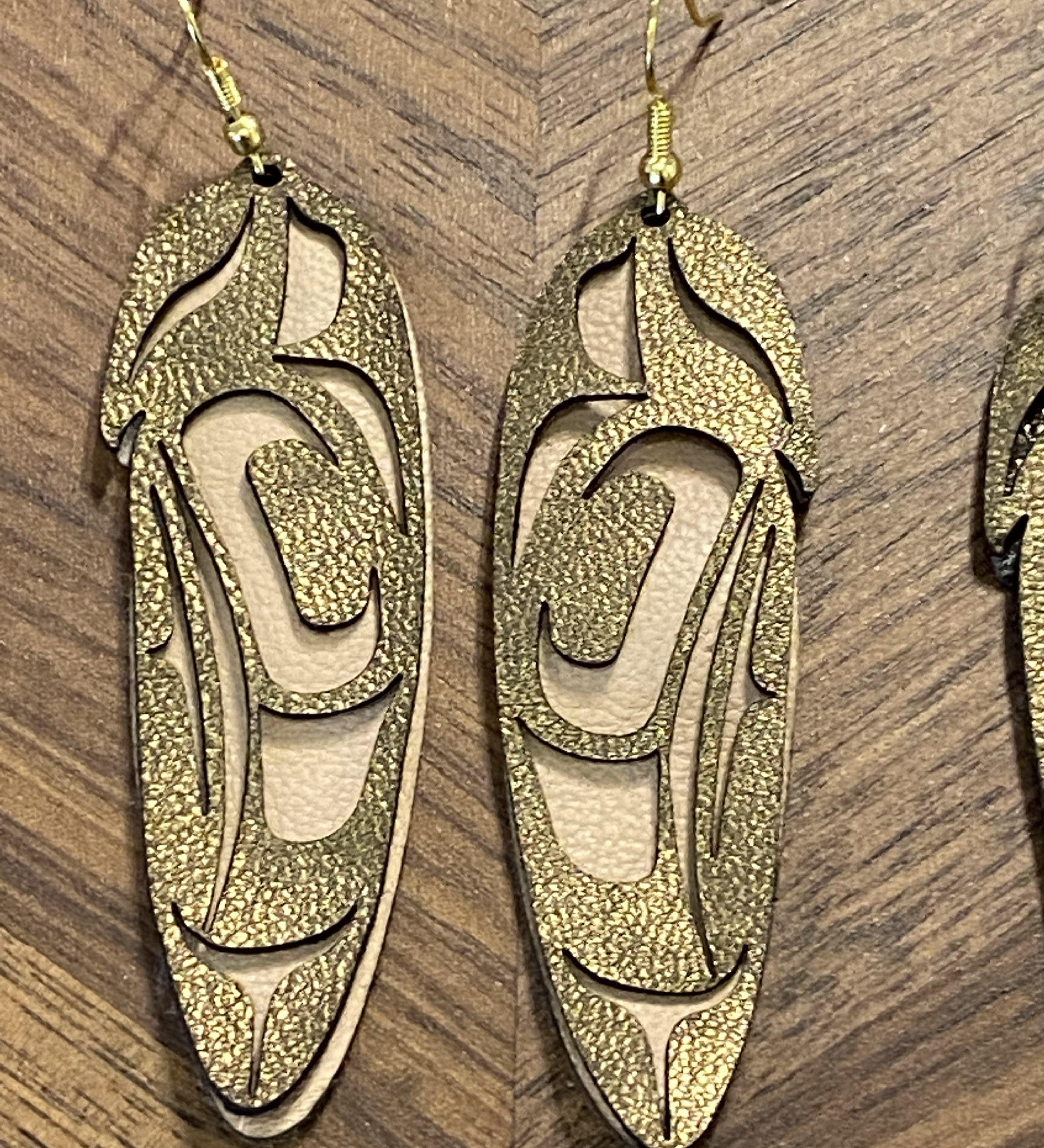 Close up of feather earrings by indigenous artist leather 5