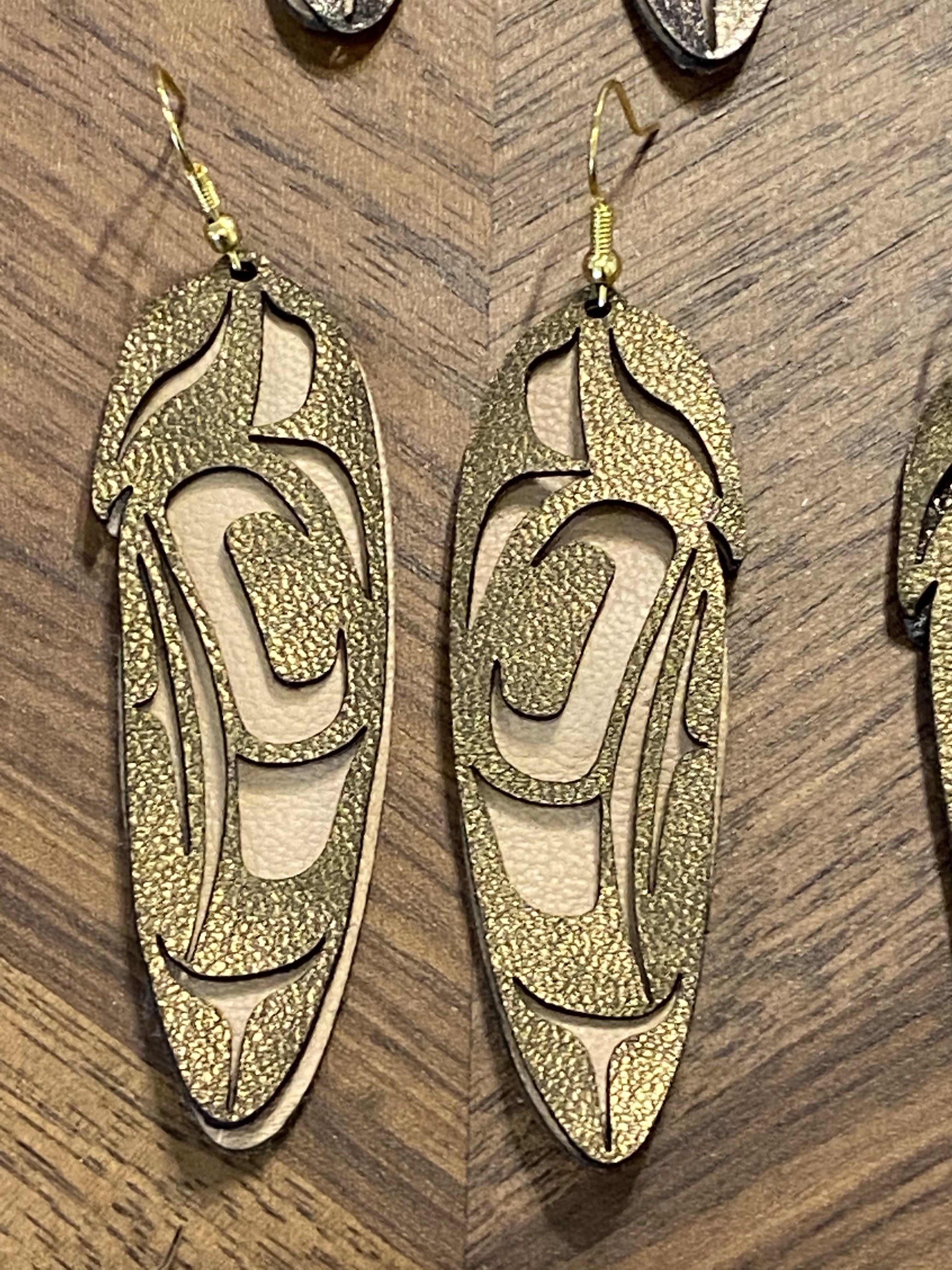 Close up of feather earrings by indigenous artist leather 5