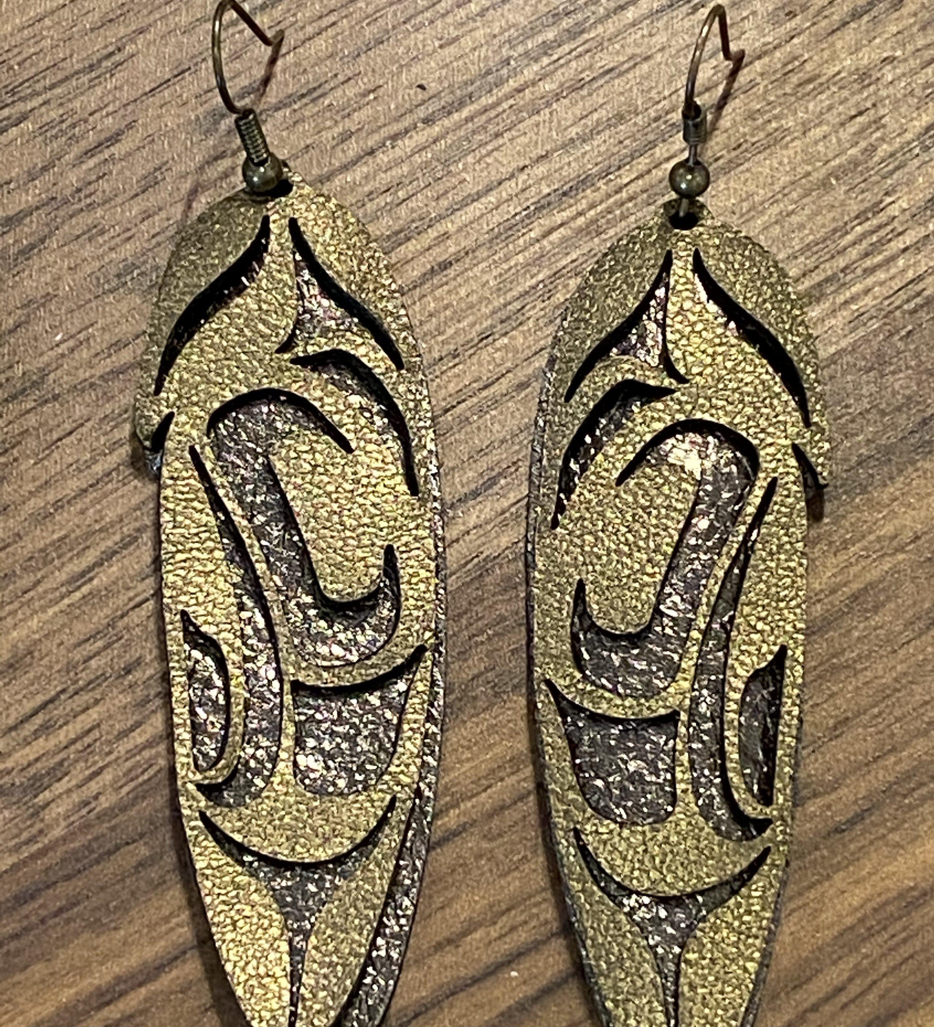 Close up of feather earrings by indigenous artist leather 6