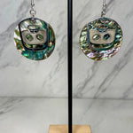 Close up up of ghost face earrings by indigenous artist abalone and silver 2