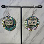 Close up up of ghost face earrings by indigenous artist abalone and silver 3