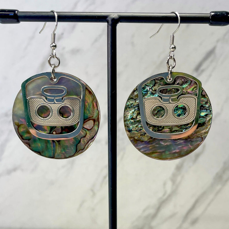 Close up up of ghost face earrings by indigenous artist abalone and silver