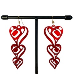Close up up of heart drops earrings by indigenous artist acrylic