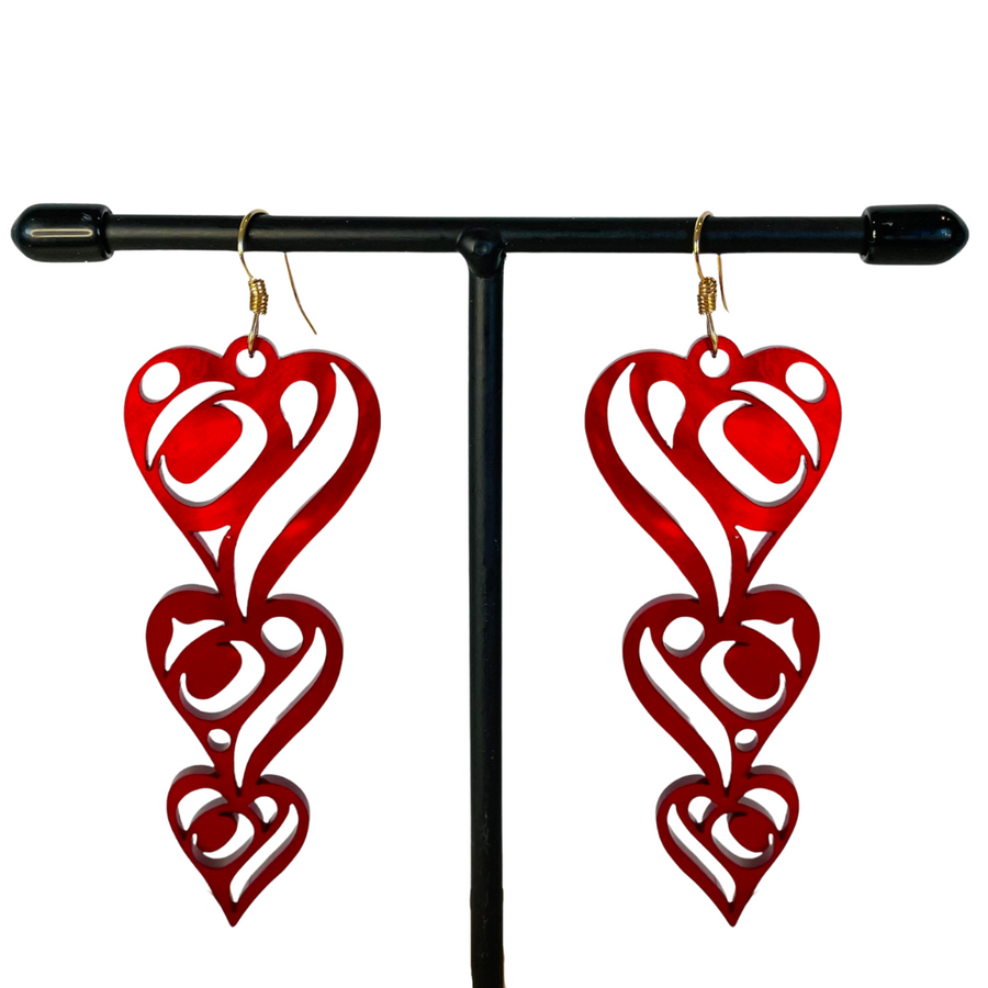 Close up up of heart drops earrings by indigenous artist acrylic