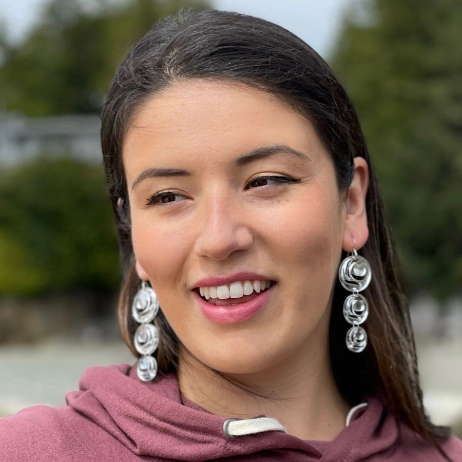 Model wearing earrings Moon Drops by indigenous artist acrylic 2