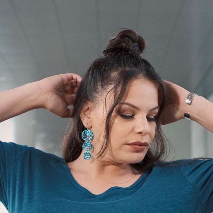 Model wearing earrings Moon Drops by indigenous artist acrylic 3