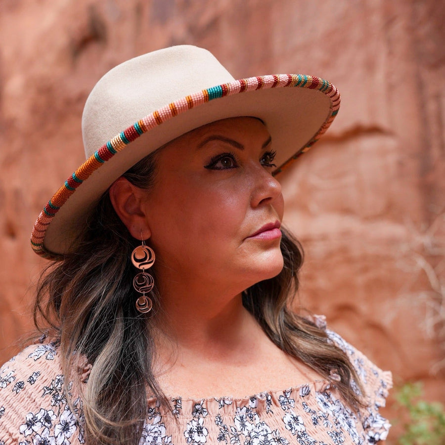 Model wearing earrings Moon Drops by indigenous artist acrylic