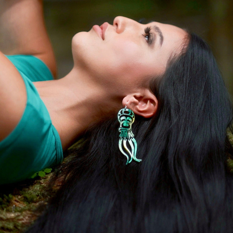 Model wearing octopus earrings by indigenous artist acrylic