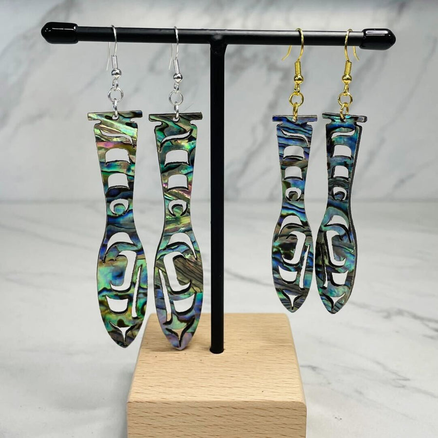 Close up of paddle acrylic and abalone earrings by indigenous artist
