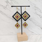 Close up up of plains points earrings by indigenous artist acrylic 3