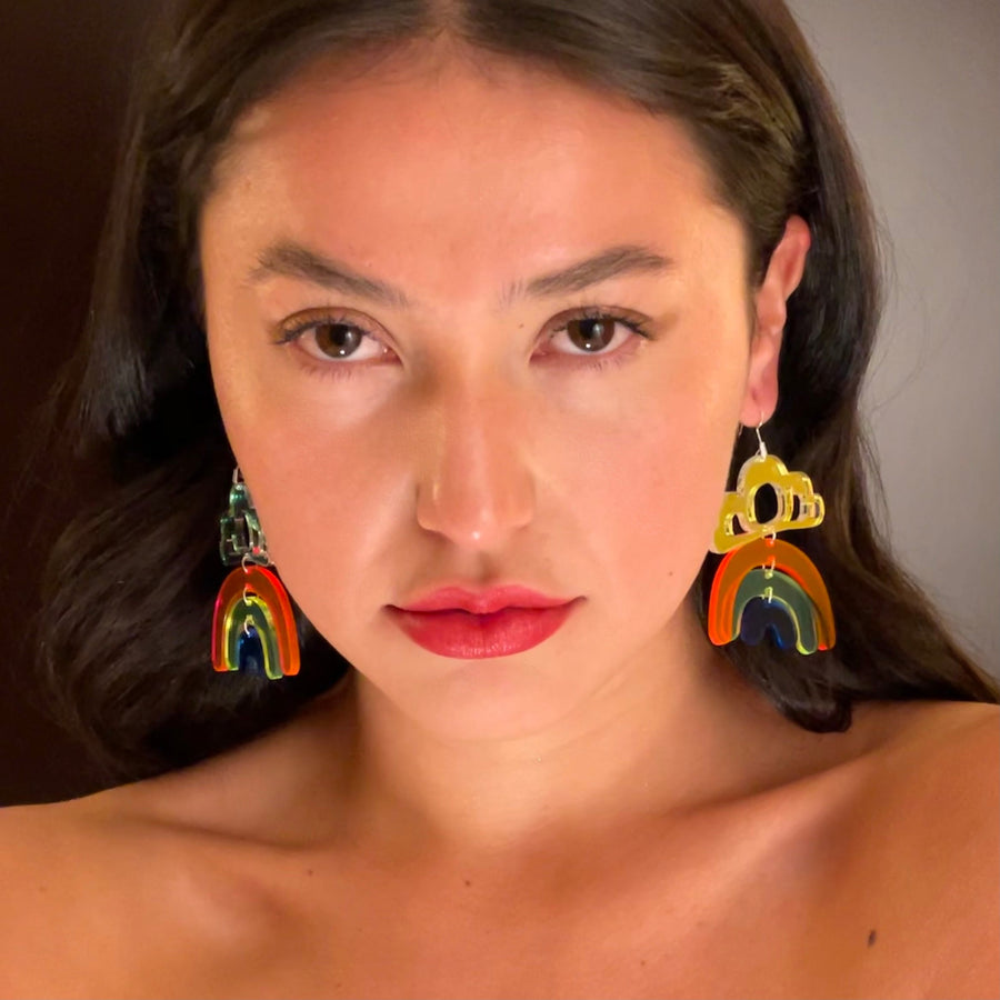 Model wearing pride rainbow earrings by indigenous artist acrylic