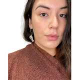 Model wearing silver raven head earrings by indigenous artist 2