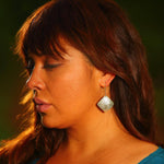 Model wearing earrings silver square eagle by indigenous artist