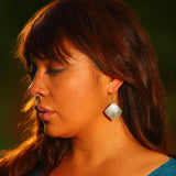 Model wearing earrings silver square eagle by indigenous artist