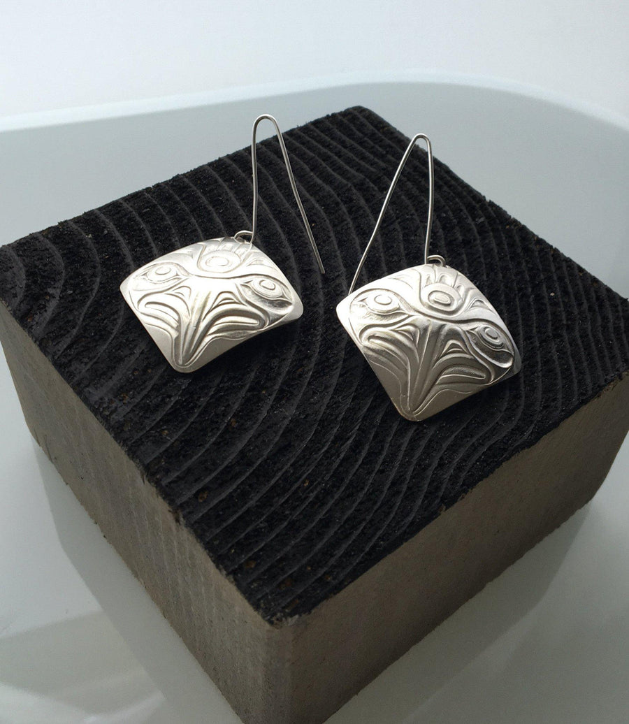 Close up of earrings silver square eagle by indigenous artist in black box