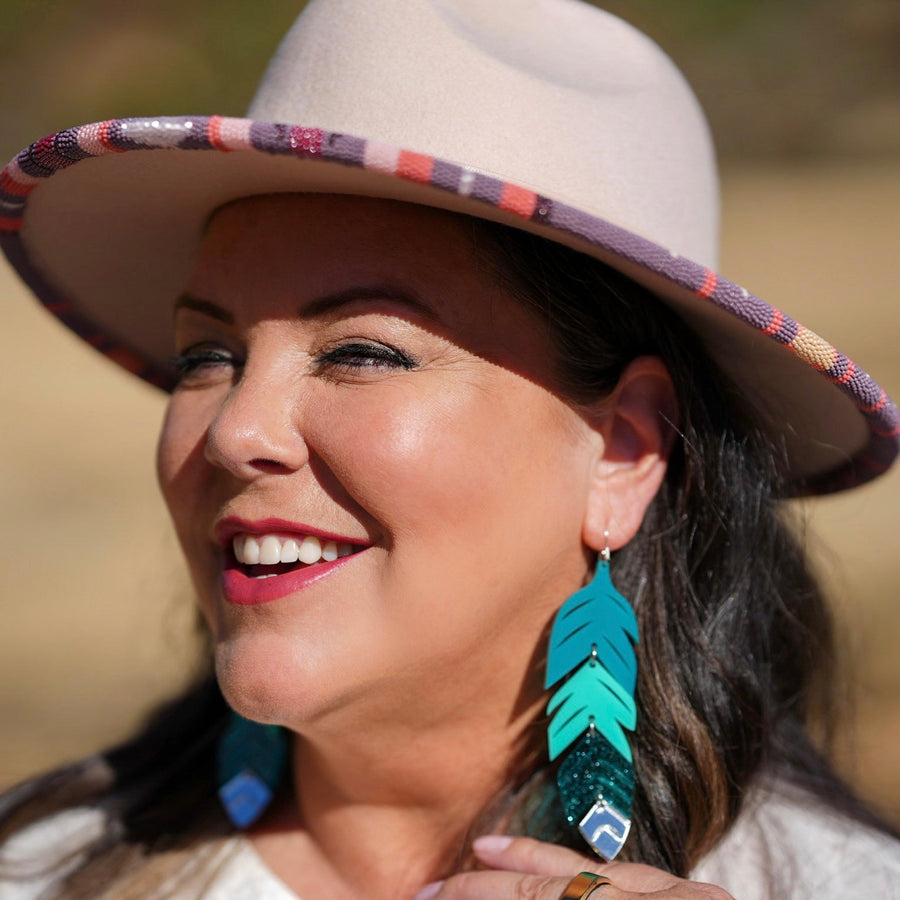 Close up up tiered feather earrings by indigenous artist acrylic 8