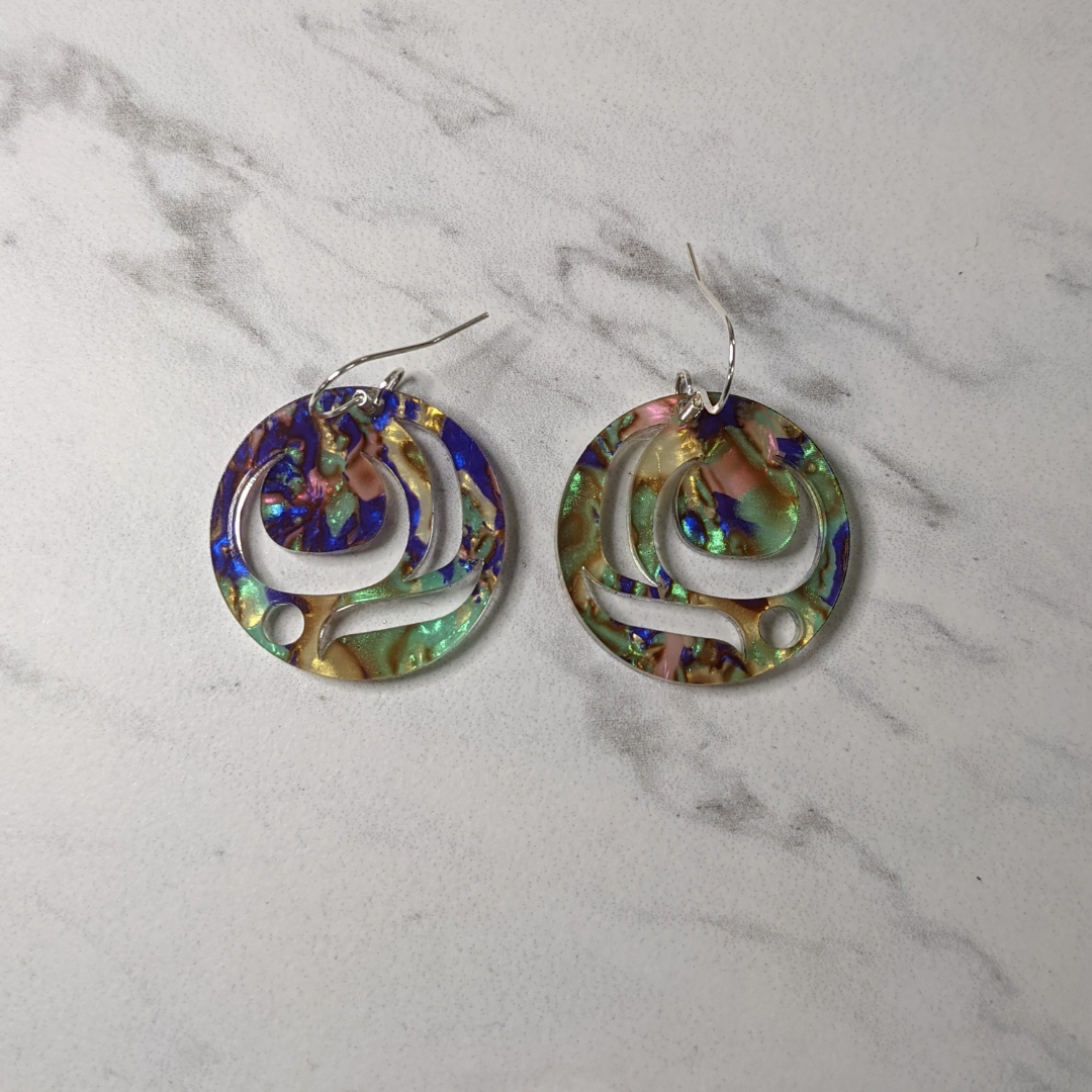 Close up of salmon trout head earrings by indigenous artist acrylic