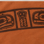 Close-up of the brown ink dowry board print on Texas Orange cotton